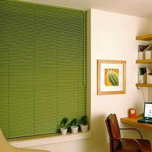 Green venetian blinds in office