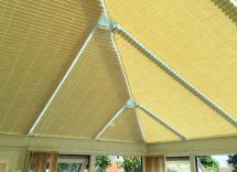 Beige roof blinds in conservatory